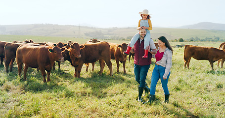 Image showing Family, farm and agriculture with a girl, mother and father walking on grass in a meadow with cows. Farmer, sustainability and field with a man, woman and daughter working together in cattle farming