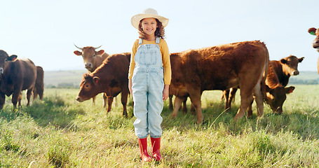 Image showing Happy, girl and farm, cow and sustainability in agriculture with a smile for growth, freedom and portrait. Countryside child, smile or kid in a field of grass, cattle and ecology livestock animals