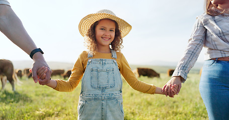 Image showing Farmer, family and girl with parents at cattle farm, holding hands and learning about livestock, family business and sustainable living. Love, agriculture and happy family bonding in nature with cows