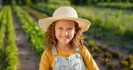 Image showing Agriculture, portrait and girl child on farm ready to help with farming or harvest. Sustainability, agro and happy little girl or kid in straw hat on land learning how to plant vegetables or plants.