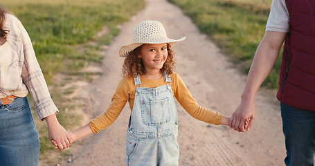 Image showing Family, farm and agriculture with a girl holding hands with her parents on a sand road in a field or meadow. Sustainability, love and summer with a daughter hand in hand with her mother and father