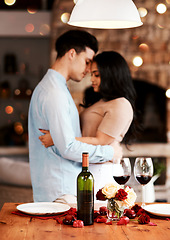 Image showing Love, wine and romance, couple hug on valentines day date at home with rose petals and bokeh. Date night, man and woman embrace in living room, valentine celebration and happy relationship together.