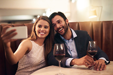 Image showing Selfie, wine and valentines day with a couple in a restaurant for a romantic fine dining celebration of love. Photograph, alcohol or anniversary with a man and woman celebrating a milestone together