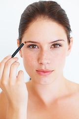 Image showing Makeup, beauty and portrait of woman with eyebrow pencil in studio for shape or grooming on white background. Face, brow and girl model with microblading tool for drawing, filling or product isolated