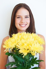 Image showing Flower bouquet, studio face portrait and happy woman with floral product, sustainable gift or yellow present. Nature growth, spring beauty and eco friendly model girl isolated on white background