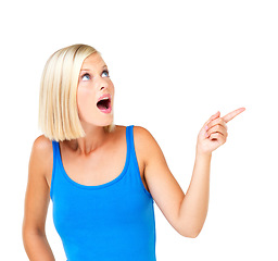 Image showing Shocked woman and pointing for space, product placement and discount girl isolated on white studio background. Young female, lady and gesture for choice, sales and advertising for deal and surprised