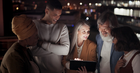 Image showing Tablet, collaboration and night with a business team working together in the city on their office balcony. Finance, teamwork and meeting with a man and woman employee group talking strategy outside