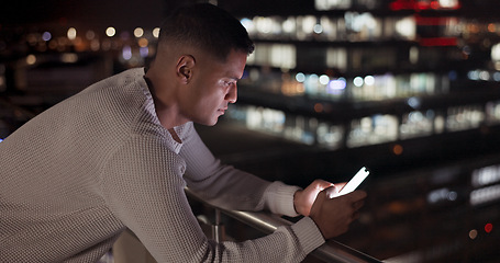 Image showing Business man, phone and night data while online on an urban building rooftop typing email, search or communication for networking on trading app. Entrepreneur on terrace in dark with 5g network