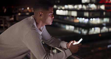 Image showing Business man, phone and night data while online on an urban building rooftop typing email, search or communication for networking on trading app. Entrepreneur on terrace in dark with 5g network