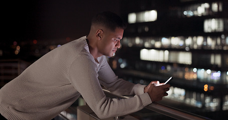 Image showing Business man, phone and night data while online on an urban building rooftop typing email, search or communication for networking on trading app. Entrepreneur on terrace in dark with 5g network