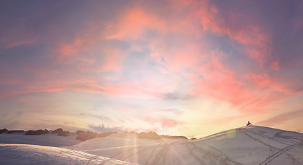 Image showing Sunset, desert and athlete riding a motorbike for extreme sports training, exercise or competition. Fitness, evening and man driving a motorcycle for a race or workout with a sand dune landscape.