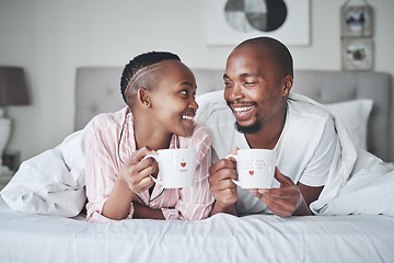 Image showing Coffee, bed and morning with a black couple together in the bedroom of their home to relax on the weekend. Love, tea or early with young man and woman relaxing while bonding in their house