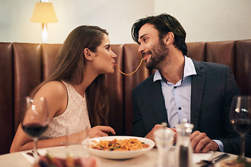 Image showing Love, happy and spaghetti with couple in restaurant sharing for romance, valentines day and date. Bonding, smile and celebration with man and woman with pasta at table for fine dining, wine and cute