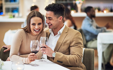 Image showing Love, wine and happy couple at a restaurant for valentines day, celebration and bonding while laughing. Alcohol, fine dining and woman with funny man on first date, anniversary or birthday dinner