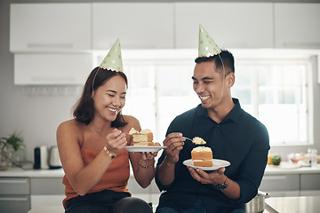 Image showing Birthday, cake and couple in a kitchen for celebration, happy and bonding in their home, smile and laughing. Party, people and man with woman on a counter for eating, fun and celebrating in Japan