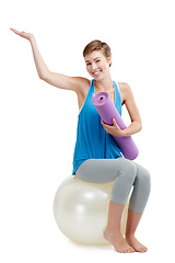 Image showing Fitness, palm and woman isolated on a white background, balance ball and product placement mockup. Happy pilates, exercise or workout person with yoga sports portrait and hand advertising in studio