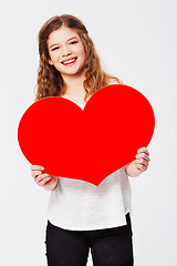 Image showing Red heart, love and portrait of girl in studio for peace, self love and affection on white background. Shape, emoji and face of teenager holding cardboard sign, loving and gesture with mockup