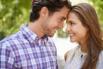 Image showing Face, love and couple in park with forehead, touch and bonding against a blurred background. Happy, embrace and man with woman in nature, smile and excited on Valentines Day for relationship and date