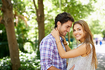 Image showing Couple, portrait and hug in park happy, touch and bonding against with love. Date, embrace and man with woman in nature, smile and excited for reunion, relationship and Valentines Day