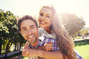 Image showing Couple portrait, smile and piggyback on love, valentines day or romance date in park bonding, garden backyard or nature. Happy, man and carrying woman in fun game, freedom security or energy support