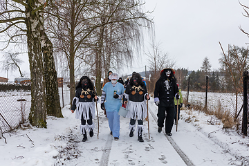 Image showing Peoples in mask attend Masopust or the Mardi Gras carnival, traditional ceremonial door-to-door procession. 