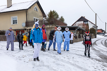 Image showing Peoples in mask attend Masopust or the Mardi Gras carnival, traditional ceremonial door-to-door procession. 