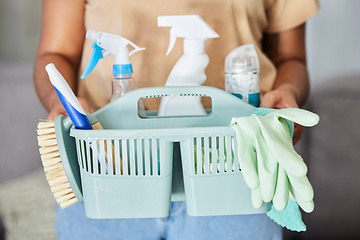 Image showing Cleaning, supplies and basket in the hands of a woman housekeeper for domestic hygiene or sanitizing. Covid, service and housekeeping with a female cleaner holding a container of disinfectant