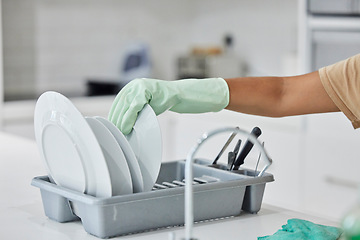 Image showing Woman hand, plate dishes and sink in kitchen for washing, cleaning and hygiene in house chores with gloves. Cleaner lady, hand and home for clean, stop bacteria and service for wellness in apartment