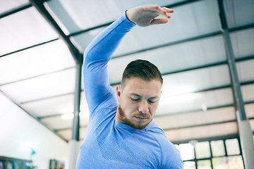 Image showing Fitness, gymnastics and man stretching arms ready to start training, exercise and workout in gym. Sports, motivation and face of male athlete with focus for balance, body performance and competition