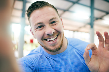 Image showing Fitness, selfie and portrait of a man in a gym for exercise, cardio or sport training for wellness. Sports, health and face of a healthy male athlete with a ok gesture after a workout in a studio.