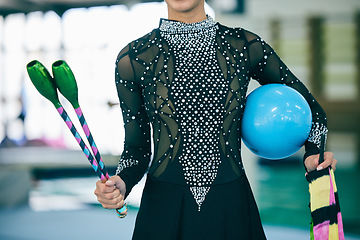 Image showing Rhythmic gymnast, dancer and gymnastic equipment in a gym for a performance exercise. Fitness, girl training and sequin dance suit of a artist with a sport ball for a competition in a sports gym