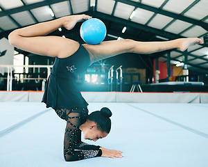 Image showing Balance, gymnastics and woman stretching with a ball for a competition, practice or training. Fitness, sports and female athlete gymnast doing a flexibility, agility and endurance exercise in a gym.