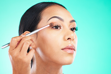 Image showing Woman, hand and face in beauty makeup, skincare or self love and care isolated against a studio background. Female hands applying eyeshadow or product with brush in cosmetics for facial treatment