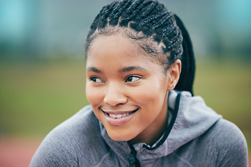 Image showing Black woman, athlete smile and face zoom of a young person ready for field running. Sport, happiness and motivation of a runner athlete outdoor with blurred background on a fitness and workout break