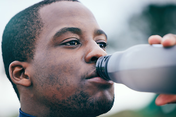 Image showing Fitness, break and face of black man drinking water to hydrate after running, exercise and workout. Health, sports and African athlete with a bottle drink after training, sports and cardio in Germany