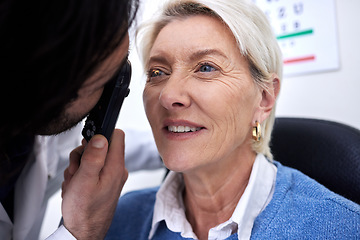 Image showing Optometry, eye check and woman with an optician for healthcare, consultation and vision exam. Lens test, health and senior patient with a male ophthalmologist with a light to look at visual problem