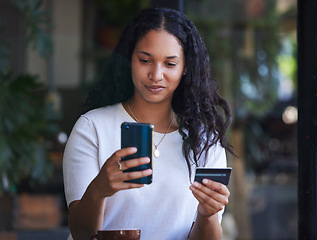 Image showing Credit card, woman and smartphone for online shopping, outdoor and purchase clothes. Female shopper, lady and customer with cellphone, ecommerce and purchase clothes for sale, discount and in city