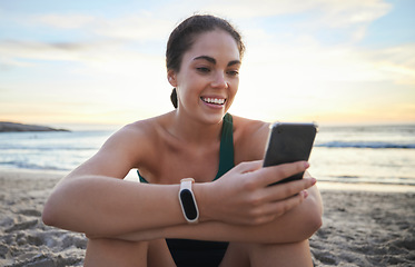 Image showing Beach, relax and happy woman on a phone browsing on the internet, online or a mobile app. Happiness, smile and female networking or scrolling on social media with a cellphone by the ocean at sunset.