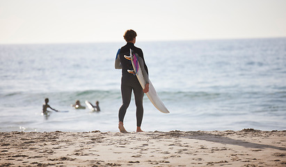 Image showing Surfing on beach, man with surfboard for sports outdoor, ocean and travel with mockup space and nature. Adventure, extreme sports and athlete walking, active lifestyle with surf on sea waves in Miami