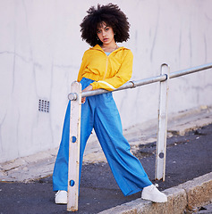 Image showing Black woman, portrait and urban fashion in the city for stylish or colorful clothing with afro hair style. African American female fashionable model posing on pavement with funky clothes in a town