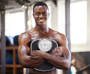 Image showing Black man, bodybuilder and gym for portrait with weight scale for muscle growth, power and wellness. Happy fitness person with training, workout or exercise motivation for goals, body and health