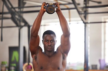 Image showing Black man with kettlebell in gym, fitness and portrait with arm muscle training, bodybuilder and weightlifting exercise. Biceps, strong and bodybuilding, focus and serious with commitment to workout