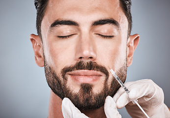 Image showing Needle, man and plastic surgery for skincare, collagen and beauty clinic in studio. Botox cosmetics, face injection and male aesthetic for body transformation, change and facial filler on background