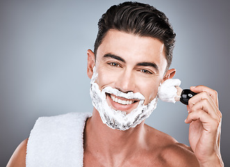 Image showing Face, shaving cream and man with brush in studio isolated on gray background for hair removal. Haircare portrait, epilation and happy male model with facial product, foam or gel to shave for wellness