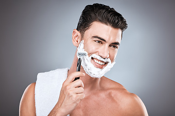 Image showing Shaving cream, face and man with razor in studio isolated on a gray background. Epilation, cleaning and thinking male model with facial product, foam or gel to shave for wellness and hair removal.