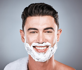 Image showing Grooming, shaving and portrait of a man with cream on face isolated on a grey studio background. Happy, hygiene and headshot of a person with a facial product for beard hair removal on a backdrop