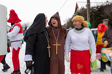 Image showing Peoples in mask attend Masopust or the Mardi Gras carnival, traditional ceremonial door-to-door procession. 