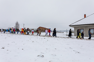 Image showing Peoples in mask attend Masopust or the Mardi Gras carnival, traditional ceremonial door-to-door procession. 