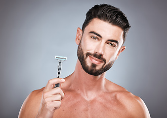 Image showing Face, portrait and man with razor in studio isolated on a gray background for shaving. Skincare, cleaning and male model with facial product to shave for wellness, health hygiene and hair removal.