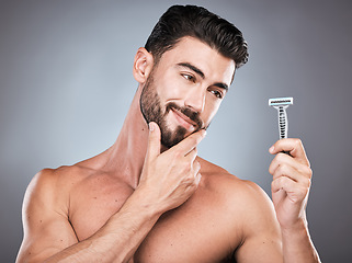 Image showing Face, man thinking and razor for shaving in studio isolated on a gray background. Ideas, haircare and male model with facial tool or product to shave for wellness, health hygiene and hair removal.